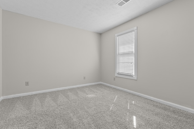 spare room featuring a textured ceiling