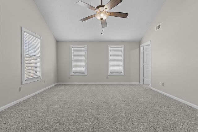 carpeted empty room featuring ceiling fan and lofted ceiling