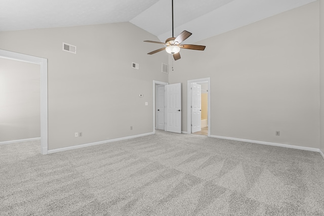 carpeted spare room with ceiling fan and high vaulted ceiling