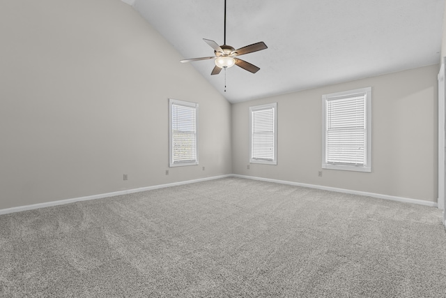 spare room with vaulted ceiling, ceiling fan, and carpet floors