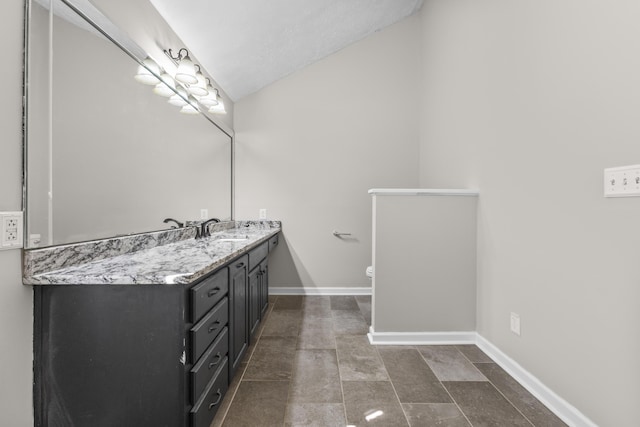 bathroom featuring a textured ceiling and vanity