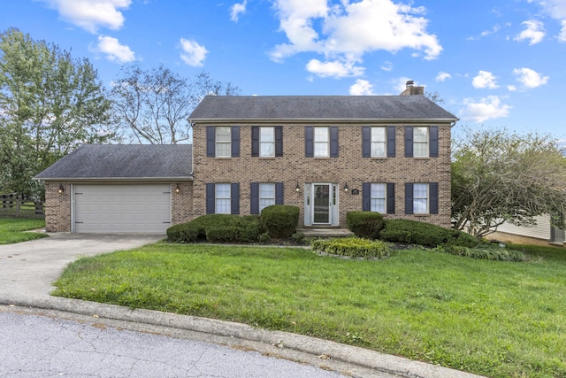 colonial-style house featuring a front lawn and a garage