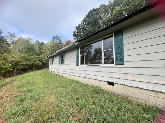 view of side of property with a yard