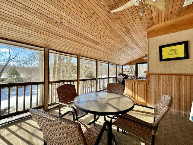 sunroom featuring ceiling fan, wooden ceiling, and vaulted ceiling