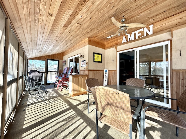 sunroom with ceiling fan and wooden ceiling