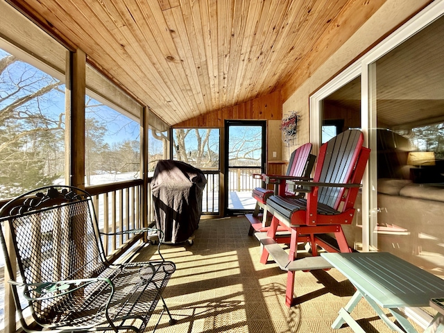 sunroom featuring vaulted ceiling and wooden ceiling