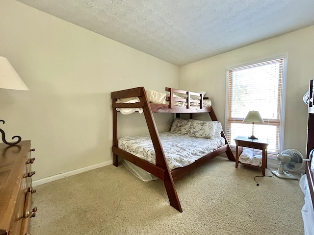 bedroom with a textured ceiling and carpet flooring