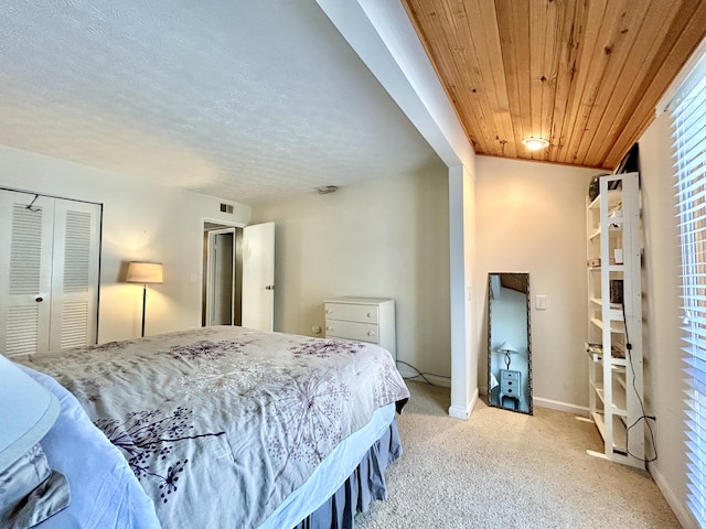 bedroom featuring light carpet, a closet, and wood ceiling