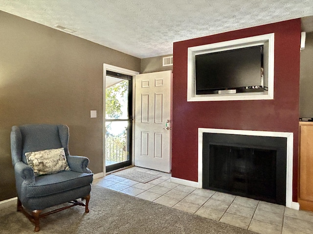 interior space featuring a textured ceiling and light tile patterned floors