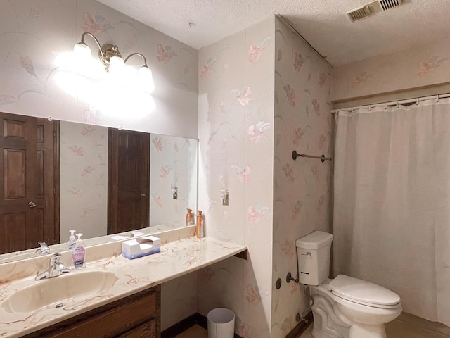 bathroom with vanity, toilet, a textured ceiling, and a shower with curtain