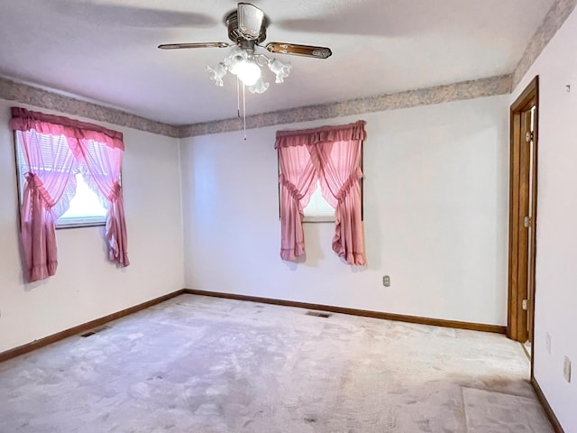 carpeted empty room featuring ceiling fan