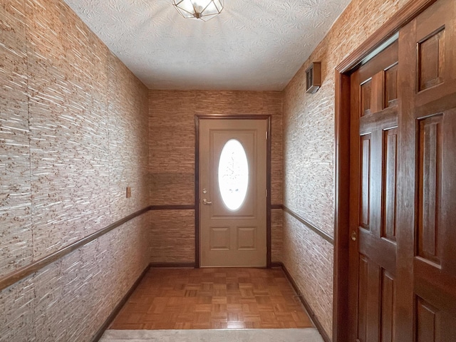 entryway featuring light parquet floors and a textured ceiling