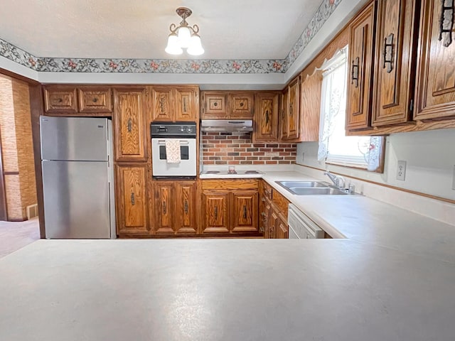 kitchen featuring sink and white appliances