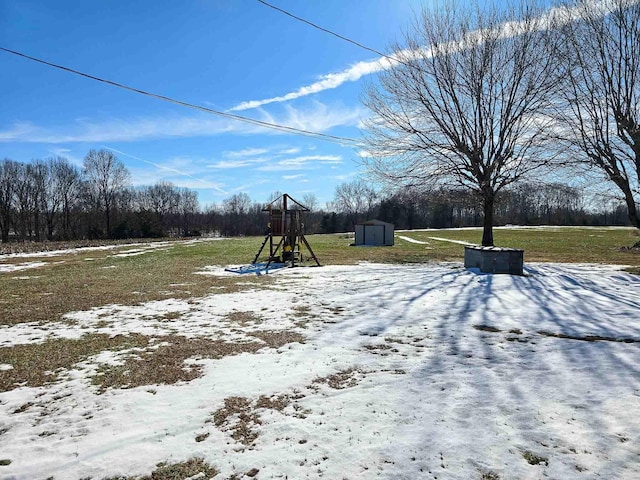 yard covered in snow with a storage shed