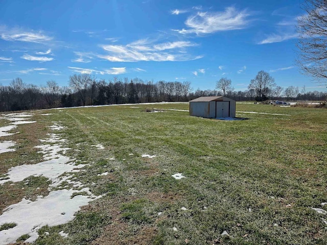 view of yard featuring a storage shed and a rural view