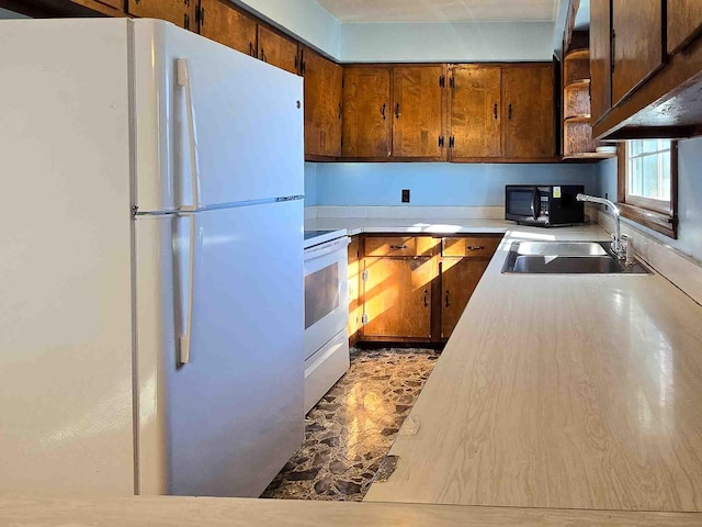 kitchen featuring sink and white appliances