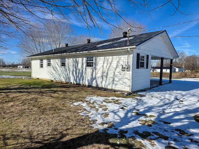 snow covered property featuring a lawn