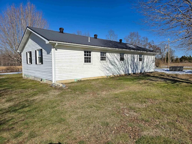 rear view of property featuring a yard