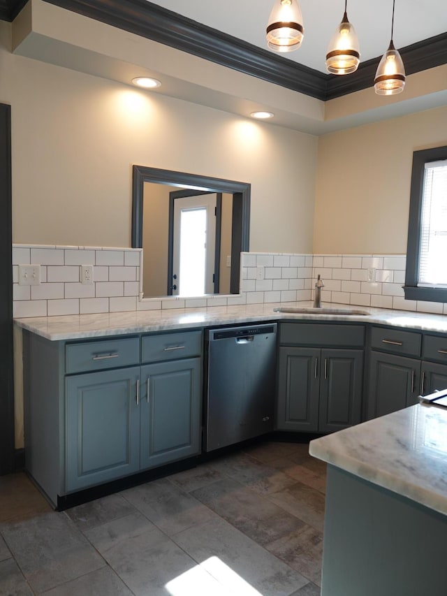 kitchen with pendant lighting, sink, backsplash, ornamental molding, and stainless steel dishwasher