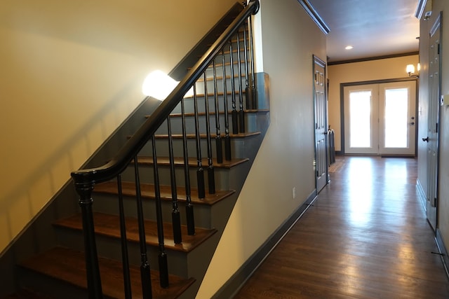 staircase with wood-type flooring and crown molding