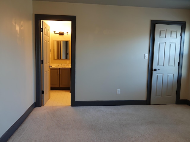 carpeted empty room featuring sink