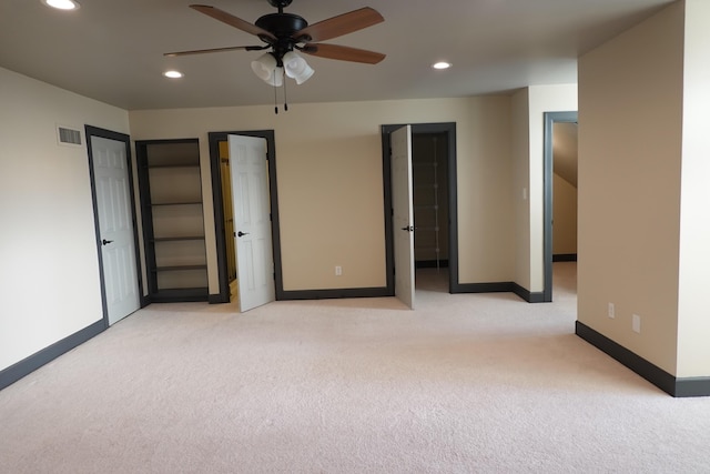 unfurnished bedroom featuring ceiling fan and light carpet