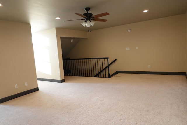 empty room featuring light carpet and ceiling fan