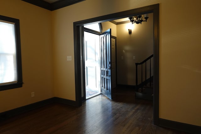 entryway with an inviting chandelier and dark hardwood / wood-style floors