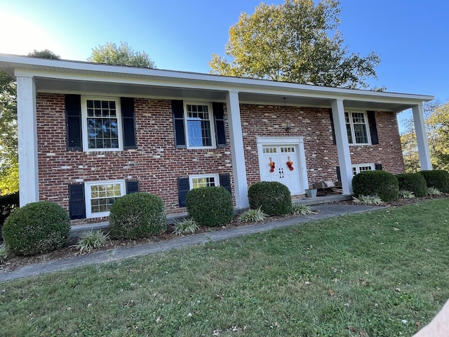 raised ranch with a front yard