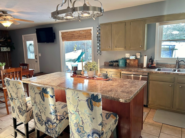 kitchen featuring a wealth of natural light, dishwasher, sink, and light tile patterned floors