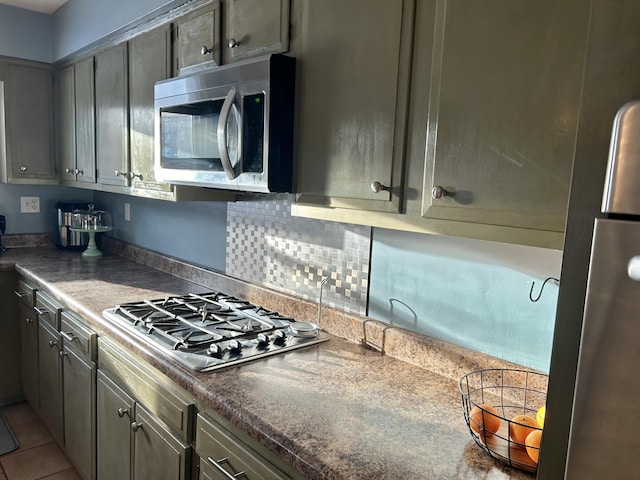 kitchen featuring light tile patterned floors, gray cabinets, and appliances with stainless steel finishes