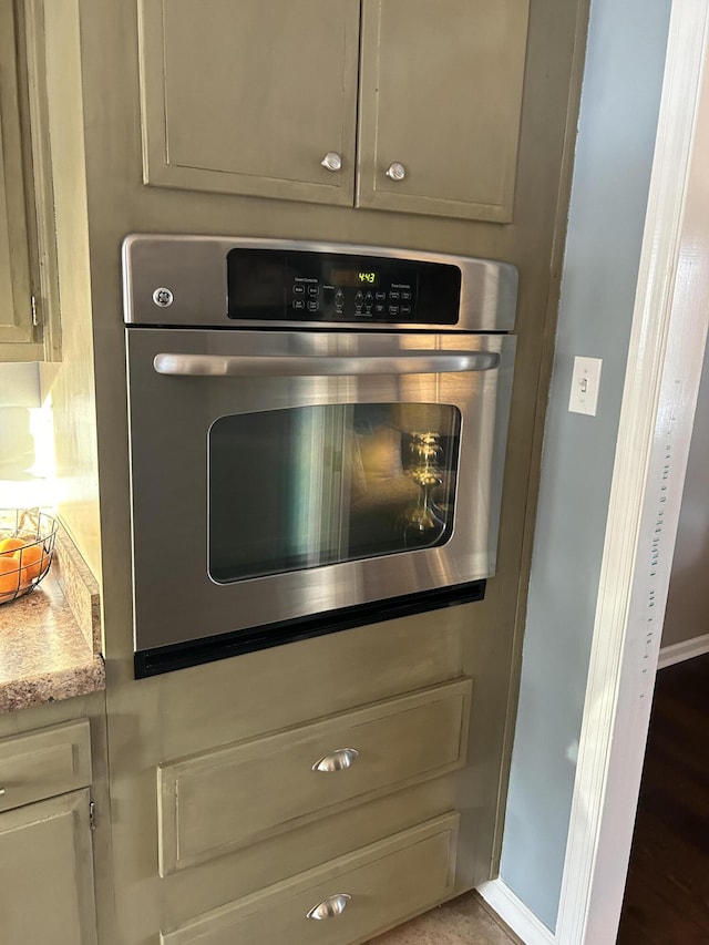 interior details with stainless steel oven and cream cabinetry