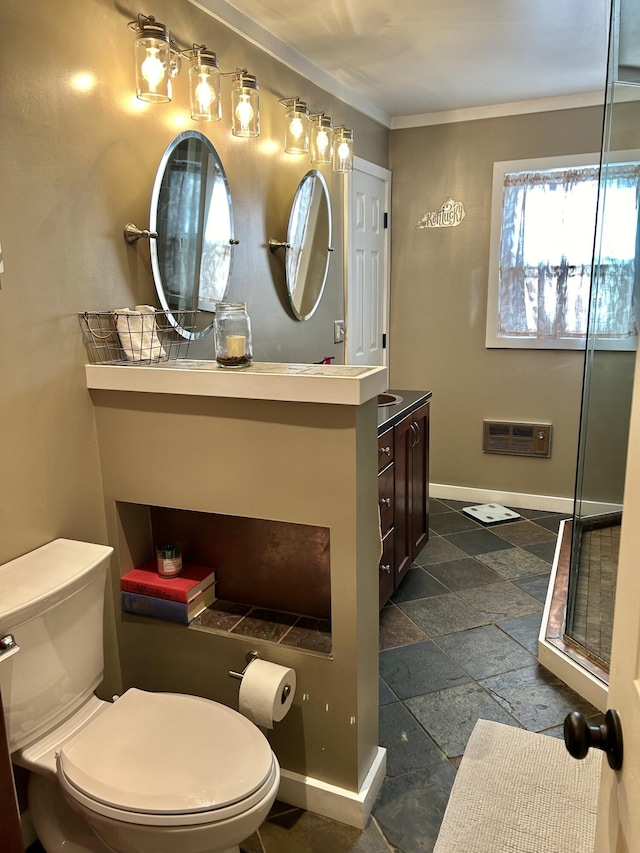 bathroom featuring toilet, ornamental molding, a shower with door, and vanity