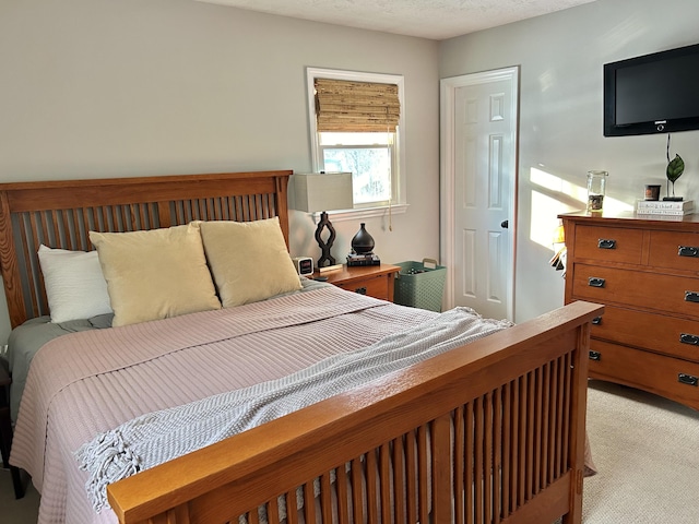 carpeted bedroom featuring a textured ceiling