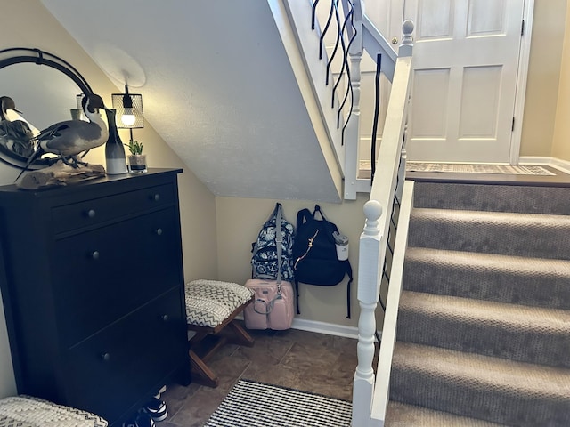 staircase with lofted ceiling