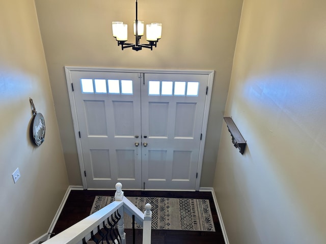 foyer featuring a notable chandelier and dark hardwood / wood-style flooring