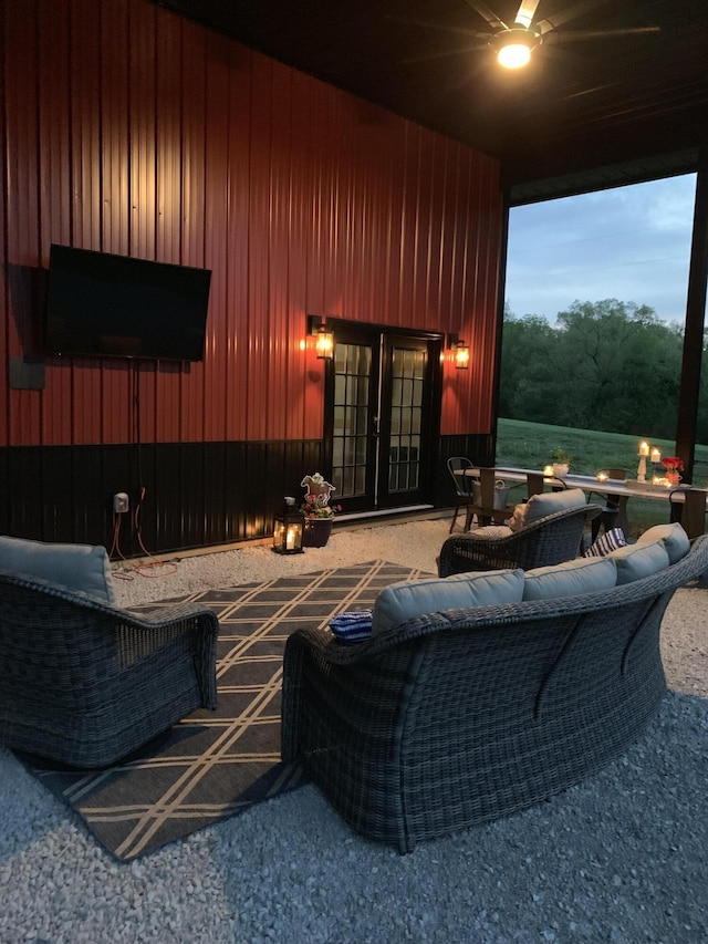 carpeted home theater room featuring french doors and wood walls