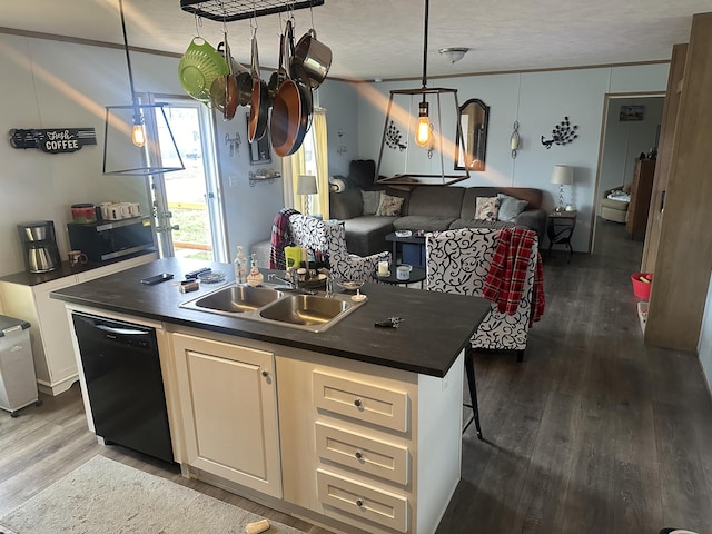 kitchen with decorative light fixtures, dishwasher, sink, an island with sink, and dark hardwood / wood-style flooring