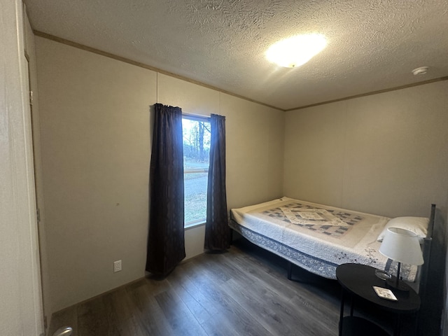 unfurnished bedroom with wood-type flooring, crown molding, and a textured ceiling