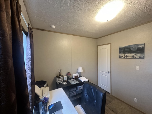 office space featuring wood-type flooring, a textured ceiling, and ornamental molding