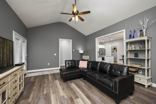 living room featuring lofted ceiling, hardwood / wood-style flooring, and ceiling fan