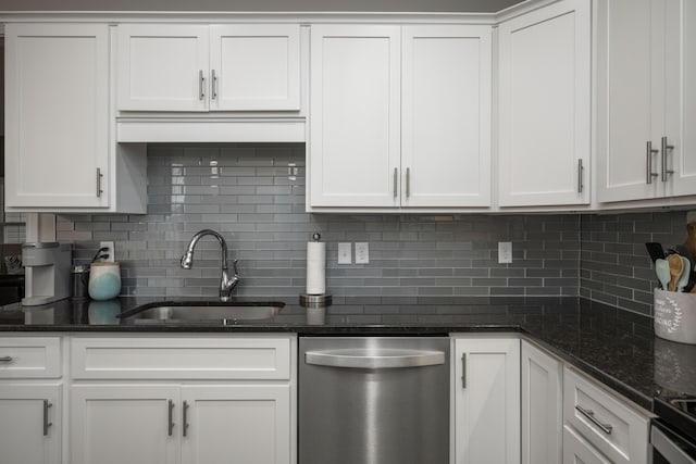 kitchen with white cabinetry, sink, stainless steel appliances, and dark stone counters