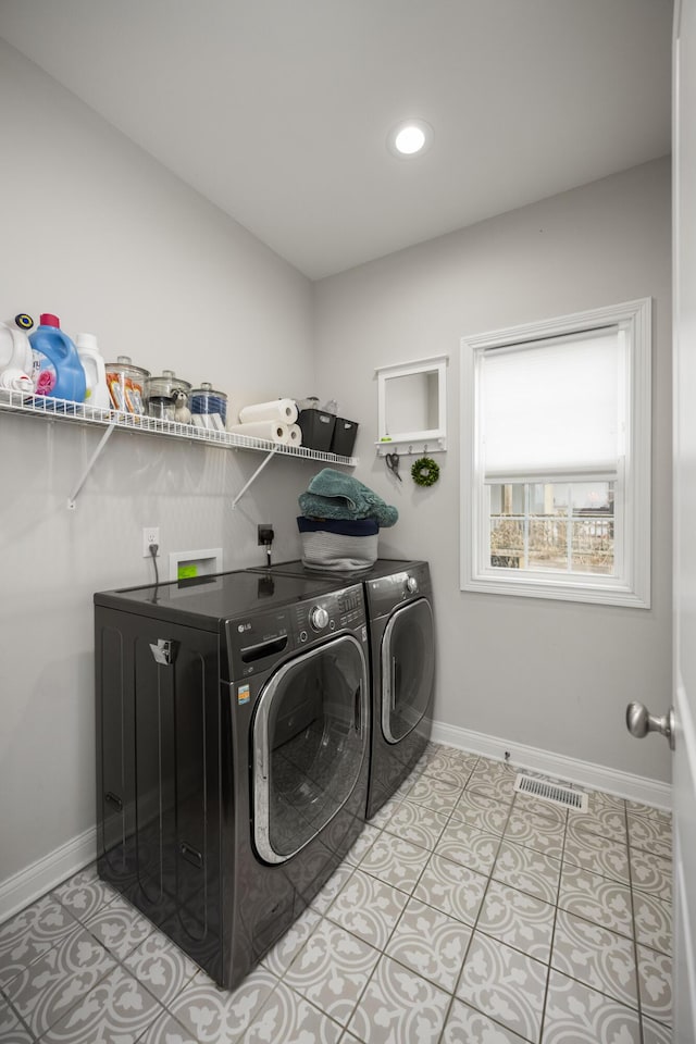 washroom featuring light tile patterned floors and washer and dryer