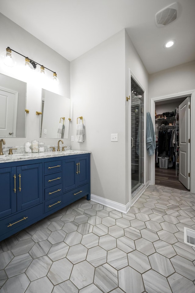 bathroom featuring vanity and a shower with door