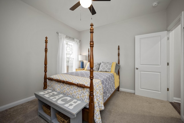 bedroom featuring ceiling fan and dark colored carpet