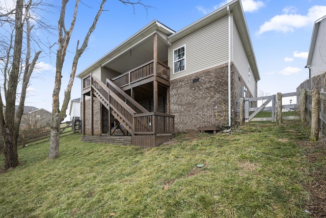 rear view of property with a balcony and a yard