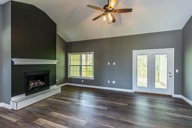 unfurnished living room with dark wood-type flooring, ceiling fan, and vaulted ceiling