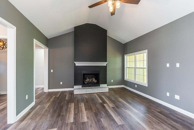 unfurnished living room featuring vaulted ceiling, a large fireplace, ceiling fan, and dark hardwood / wood-style flooring