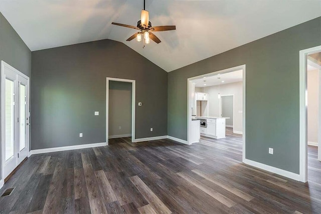 unfurnished living room with vaulted ceiling, dark wood-type flooring, and ceiling fan