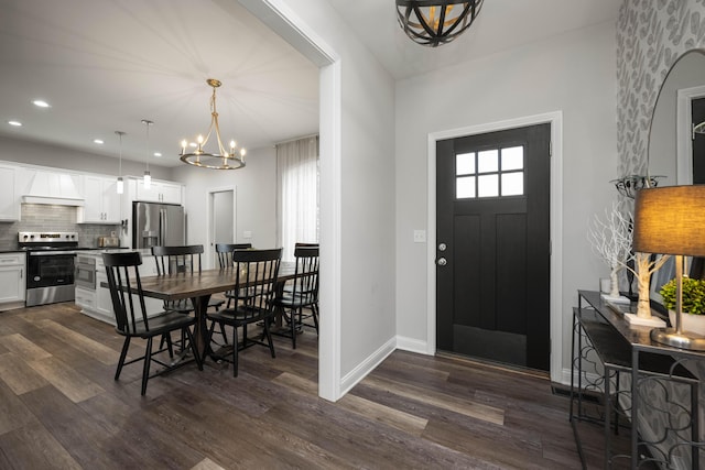 entrance foyer with dark hardwood / wood-style floors and a chandelier